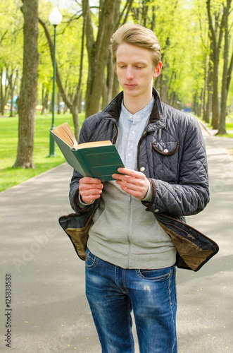 Young man reading a book 