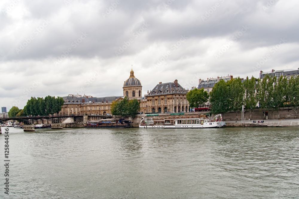 PARIS, FRANCE, MAY 16 2005. Bridge of arts, before fashion put padlocks on railings. In the background the Mazarin Library with the Academy of Fine Arts . View from the Sena River
