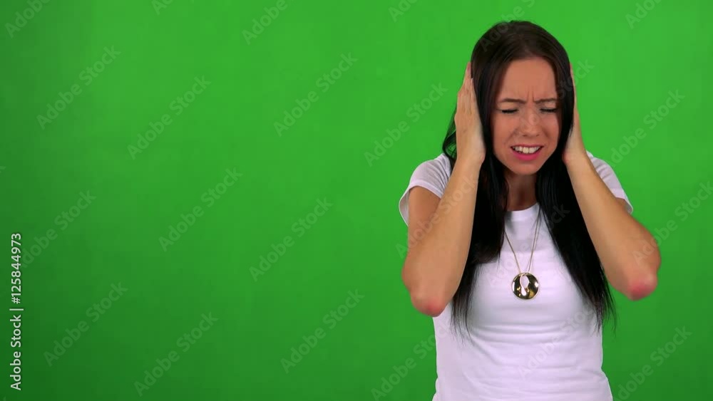 young pretty woman is afraid (woman covers his ears with hands) - green screen young pretty woman is afraid (woman covers his ears with hands) - green screen