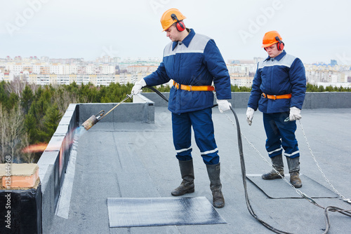Canvas-taulu Flat roof installation. Heating and melting bitumen roofing felt