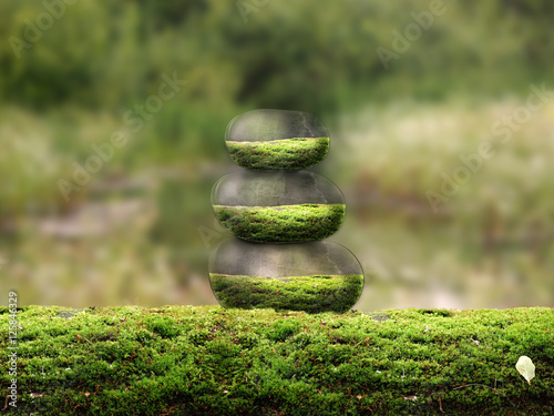 Pyramid of the beautiful volume of stones on the moss. The concept of protection of nature, environment, stability