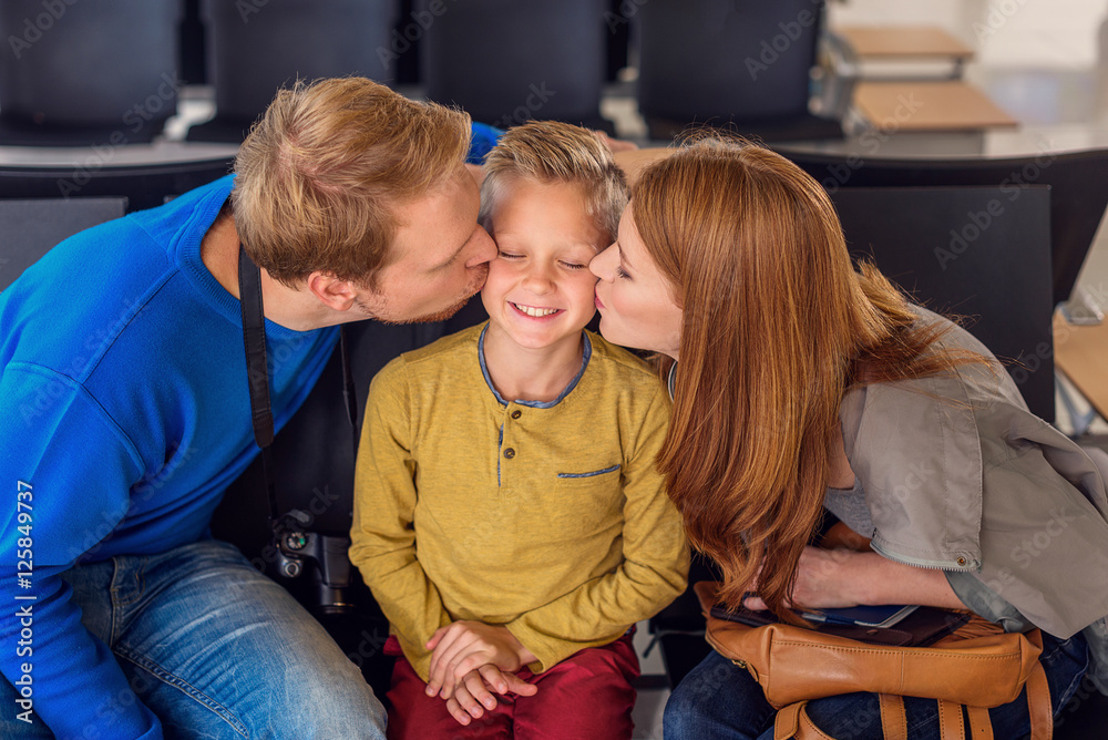 Fototapeta premium Happy family hugging at airport