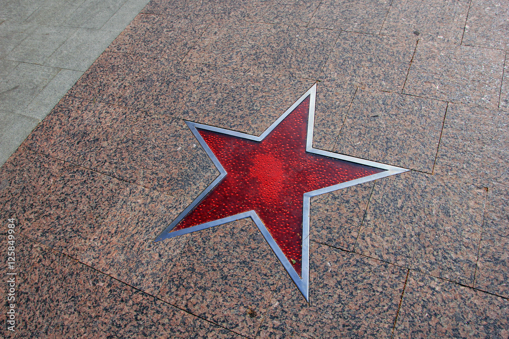 granite paving of the sidewalk with big red glass star with meta granite paving of the sidewalk with big red glass star with meta