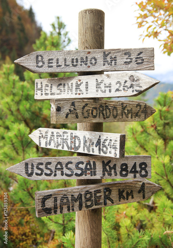 Wooden touristic sign in the Dolomites, Italy, Europe photo