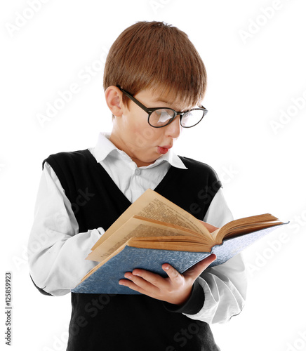 Cute schoolboy reading book...
