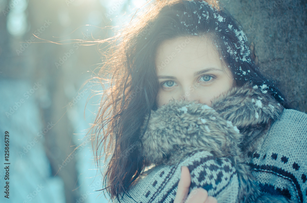 Portrait of a beautiful smiling girl near the tree in winter Portrait of a beautiful smiling girl near the tree in winter