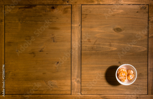 Table with mandarine bowl background