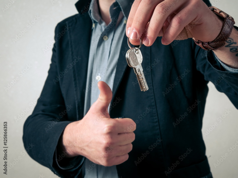 Man giving the new keys StockFoto Adobe Stock
