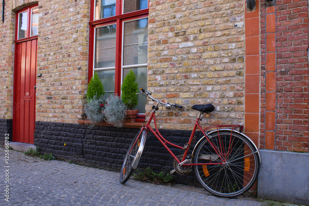 Red bicycle on the street of Bruge, Belgia