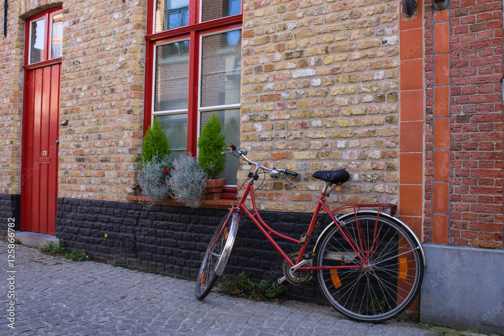 Red bicycle on the street of Bruge, Belgia Red bicycle on the street of Bruge, Belgia
