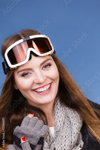 skier girl wearing warm clothes ski googles portrait.