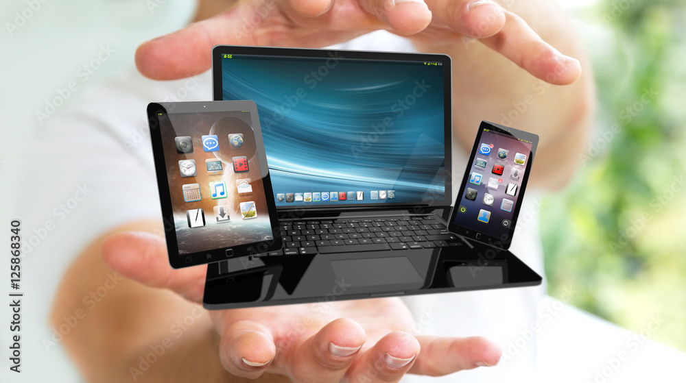 Businessman holding laptop phone and tablet in his hand 3D rende Businessman holding laptop phone and tablet in his hand 3D rende