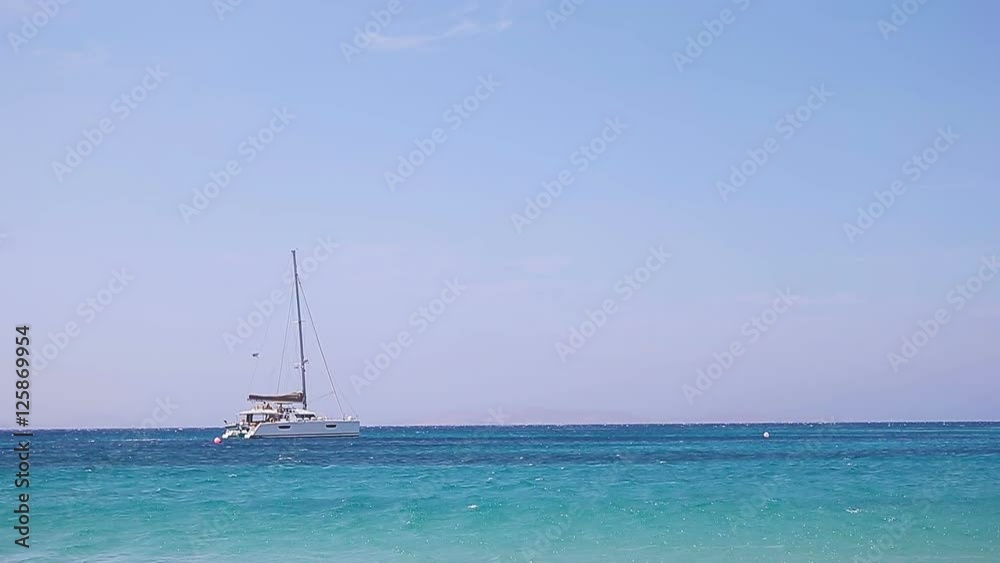 Beautiful landscape with sea view. Alone boat at the sea near the islands. Mykonos island, Greece Beautiful landscape with sea view. Alone boat at the sea near the islands. Mykonos island, Greece