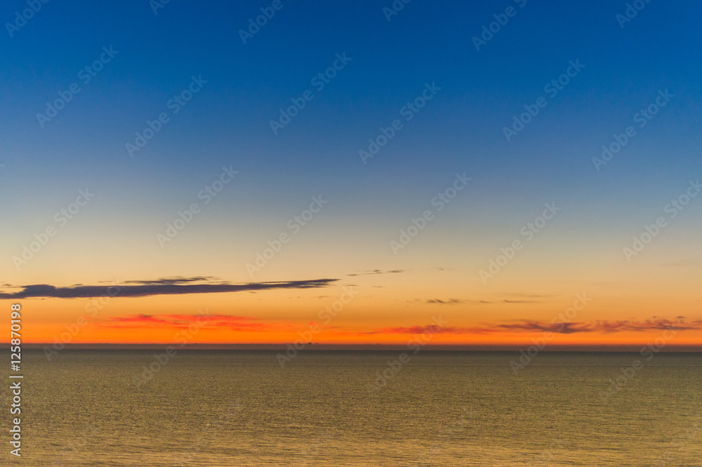 Sunrise at sea shore. Colorful sky.