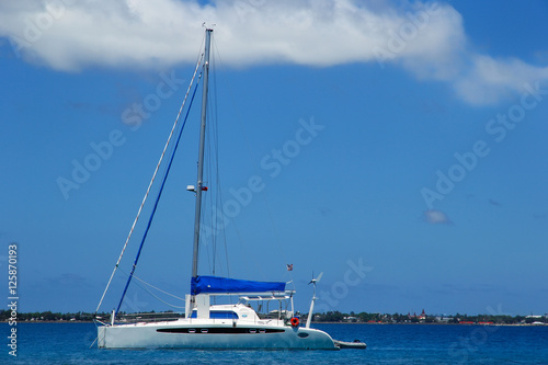 Sailboat anchired near Pangaimotu island in Tonga photo