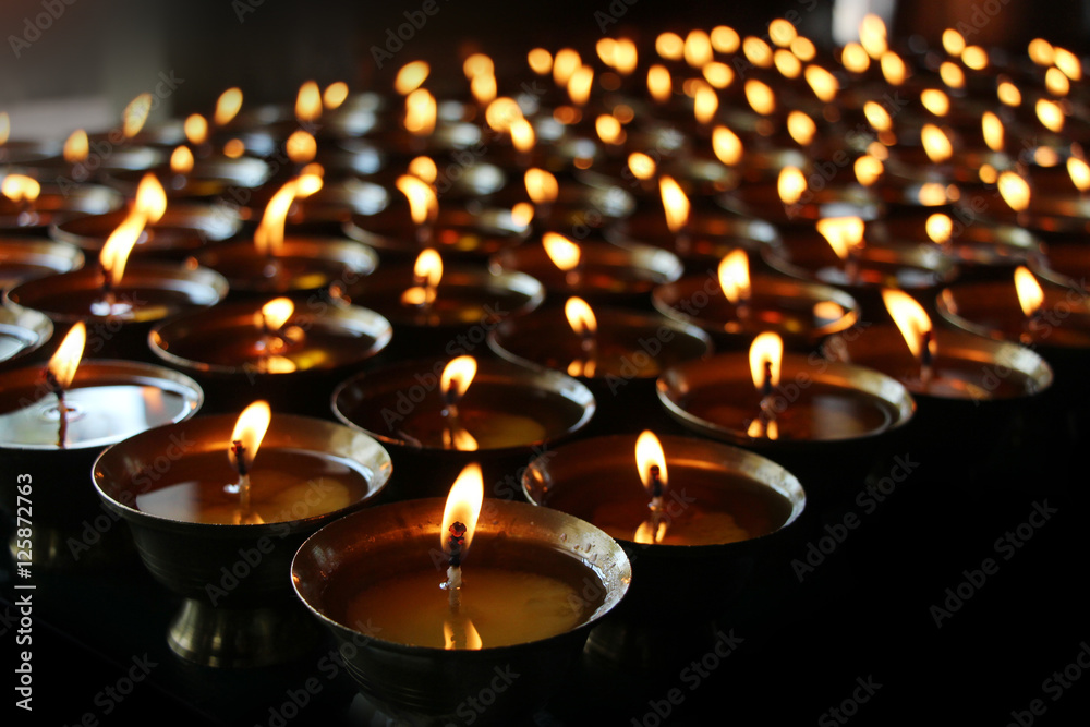  Charity. Praying candles in a temple.