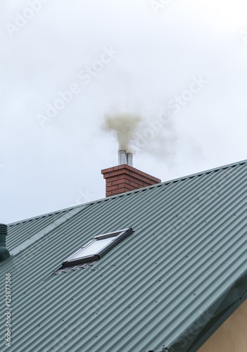 House chimney with flying smoke
