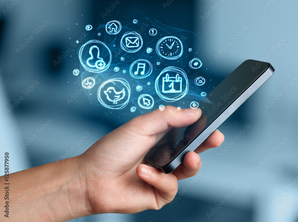 Hand holding smartphone with mobile app choices Hand holding smartphone with mobile app choices