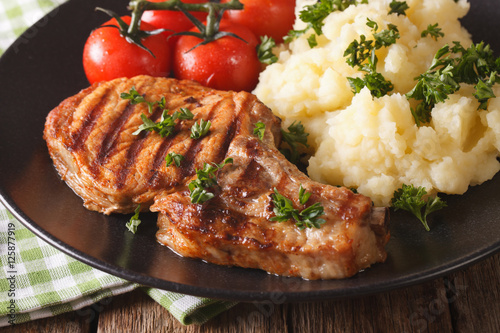 Grilled pork steak with mashed potatoes close-up. Horizontal
