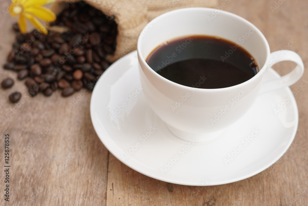 Coffee cup and coffee beans on table Coffee cup and coffee beans on table