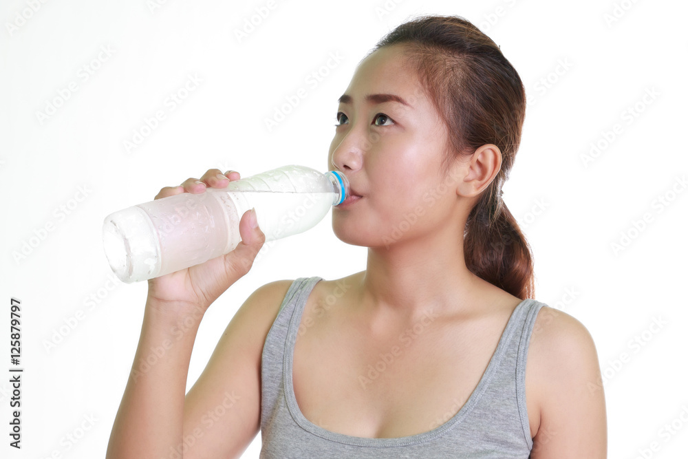Young woman drinking water on white background. Young woman drinking water on white background.