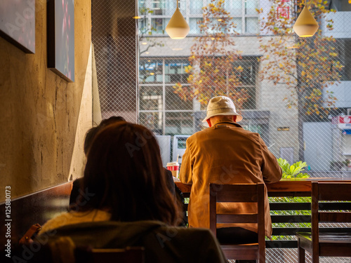 One elderly man who sat at the counter drinking coffee bar, coffee shop. © MC_Noppadol