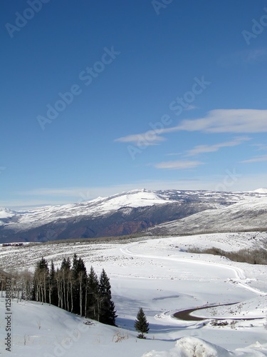 Winter day with snowy hills, blue sky,  above Vail Valley,Colorado