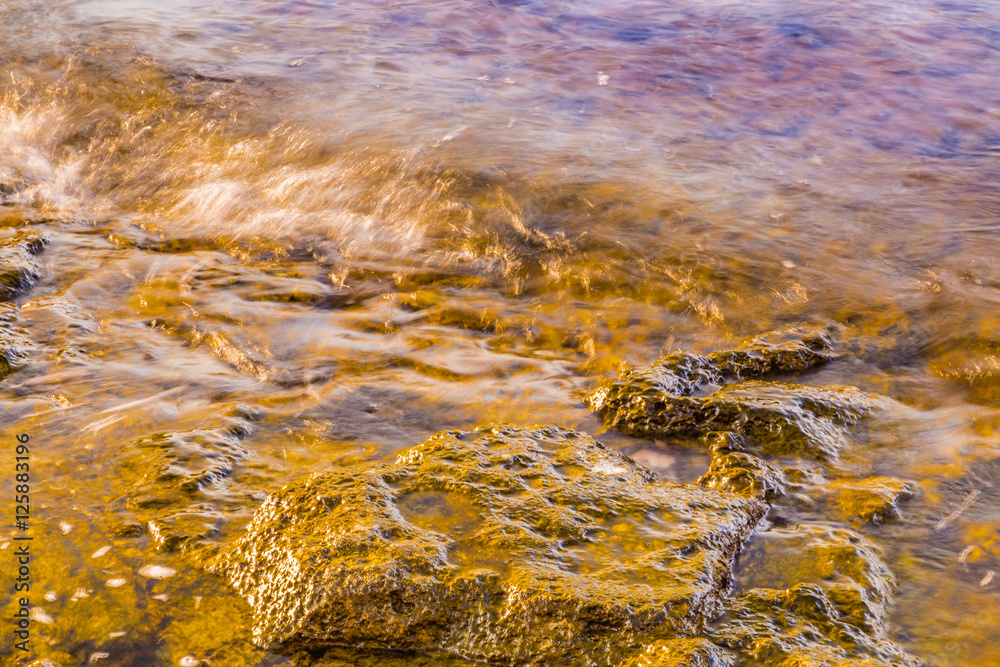 rock emerging from water rock emerging from water