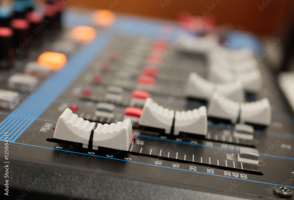 Mixer in recording room. Closeup button to increase or decrease Mixer in recording room. Closeup button to increase or decrease