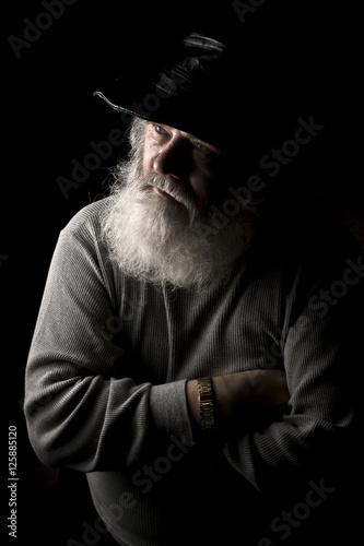 A man with a big, grey beard is sitting in the wheelchair