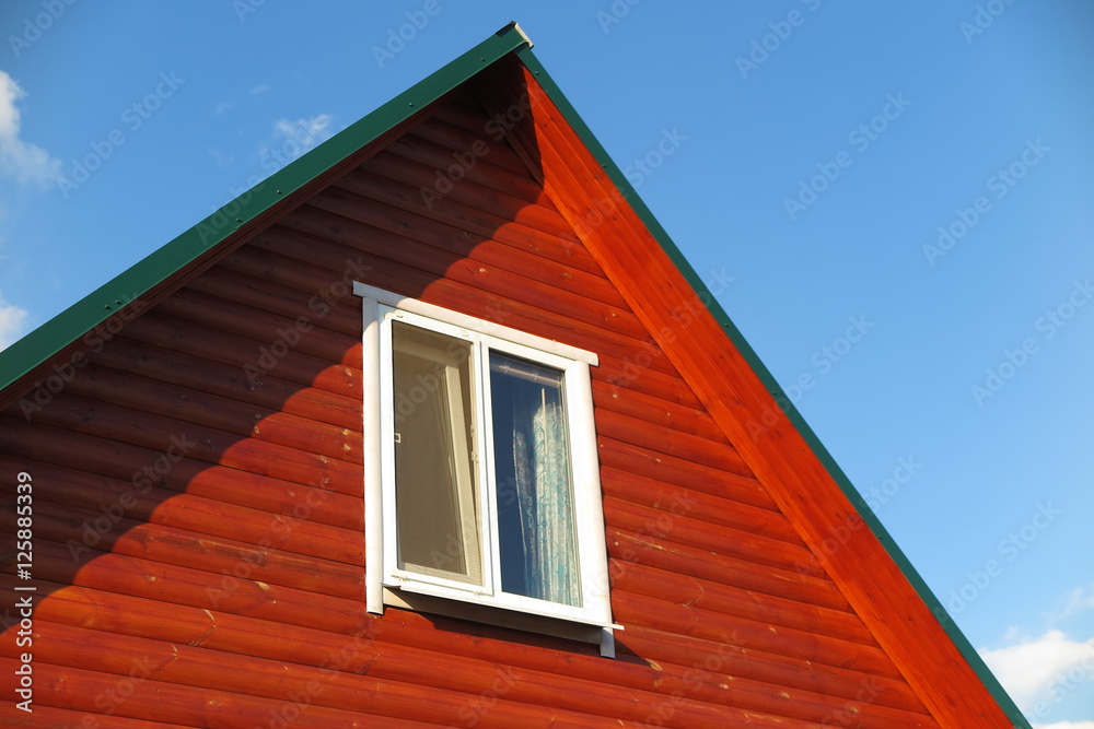 Plastic window of a modern summer cottage against a blue sky