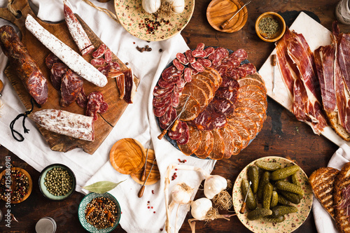 Charcuterie and cured meat cutting board. Lomo, jamon, chorizo, salchichion, fuet and sausage cuts.  photo