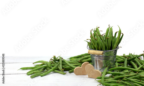 green peas in a bucket and heart. Concept. Isolated. Agriculture