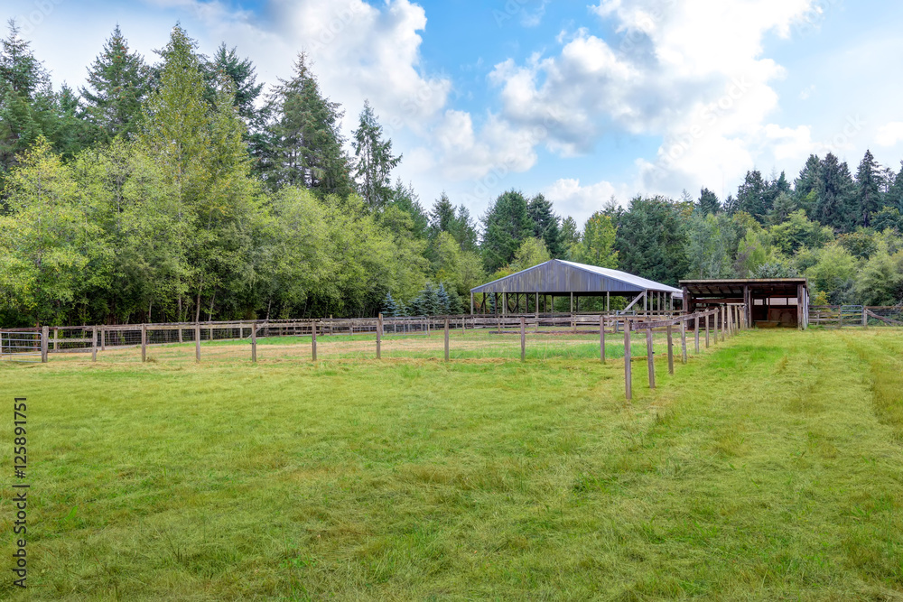Farm field with empty horse barn Farm field with empty horse barn