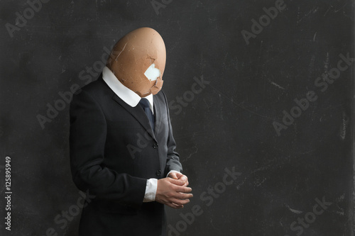 Businessman in Suit with broken Egghead