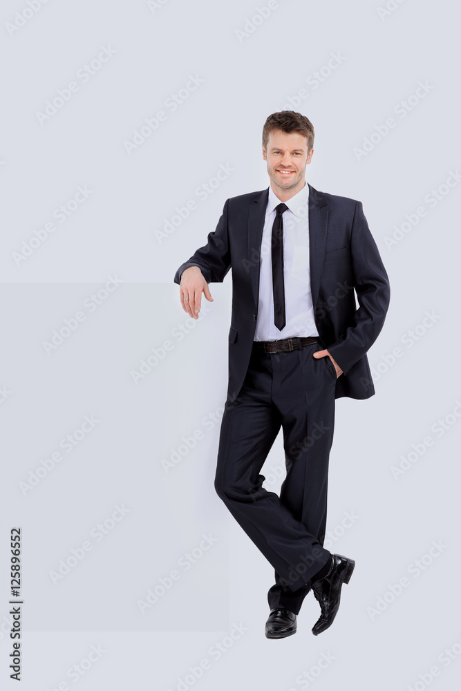Handsome business man stands next to the banner Handsome business man stands next to the banner