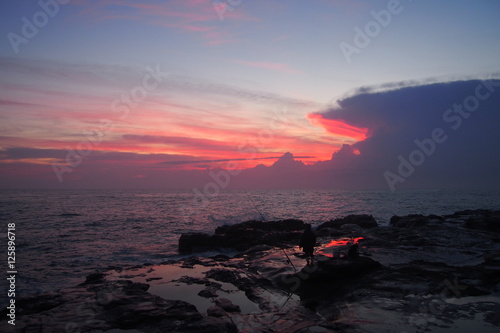 Red sky over the ocean at sunrise