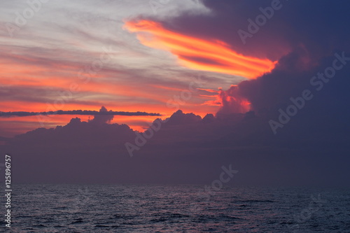 Red sky over the ocean at sunrise