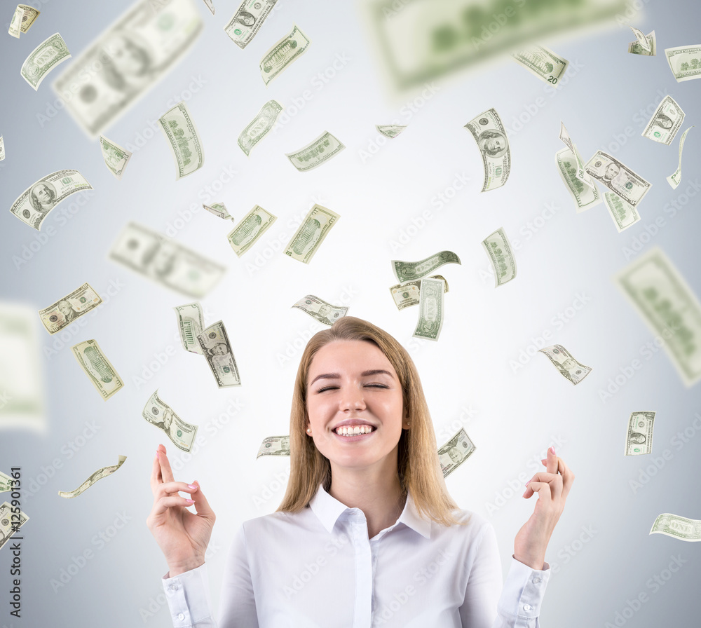 Blond woman is standing against gray background and hoping it wi