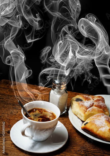 a cup of coffee and cakes on old wooden table - breakfast photo