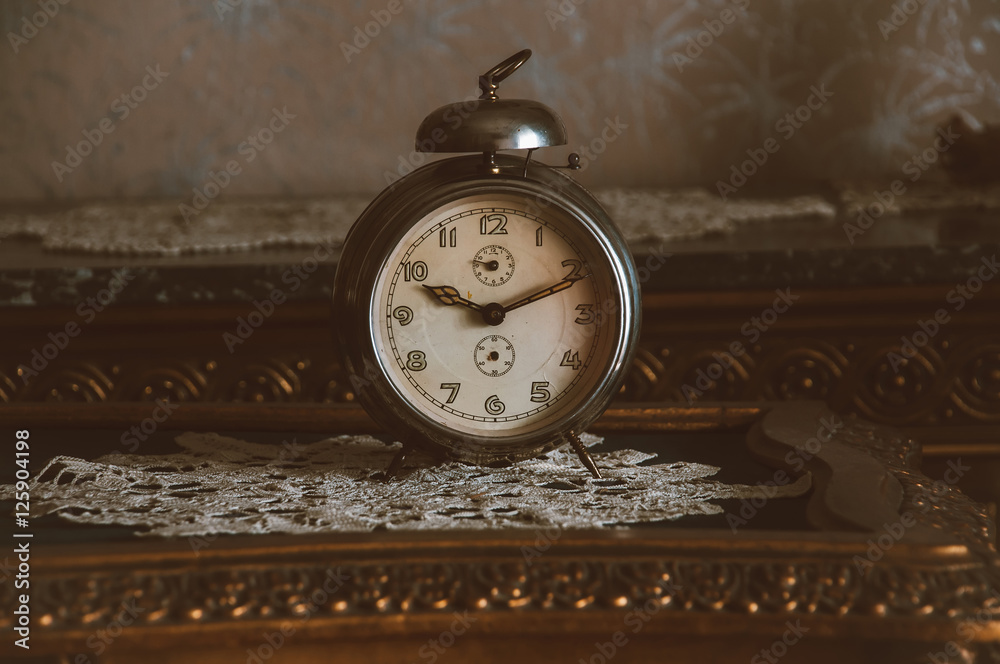 Vintage metal analog alarm clock with Arabic numbers and windup