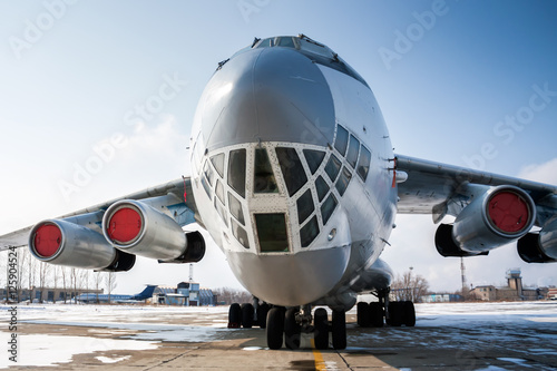 Close-up front view of widebody cargo aircraft in a cold winter airport