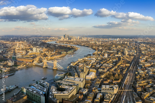 London, England - Panoramic aerial view of London with the famous Tower and Tower Bridge and skyscrapers of Canary Wharf at the background