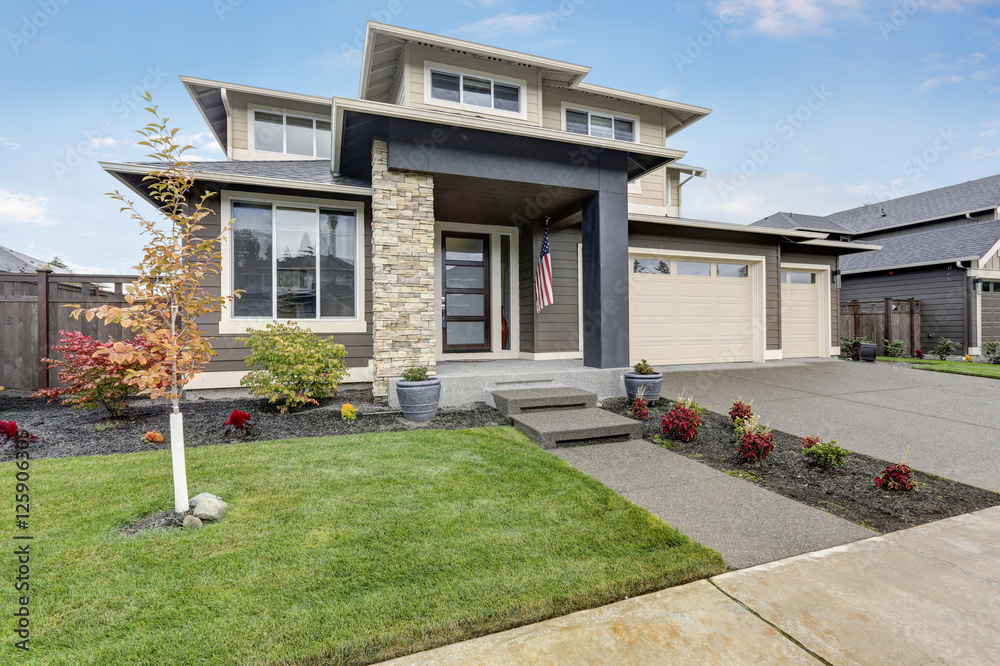 Curb appeal of brand-new home in brown and beige colors