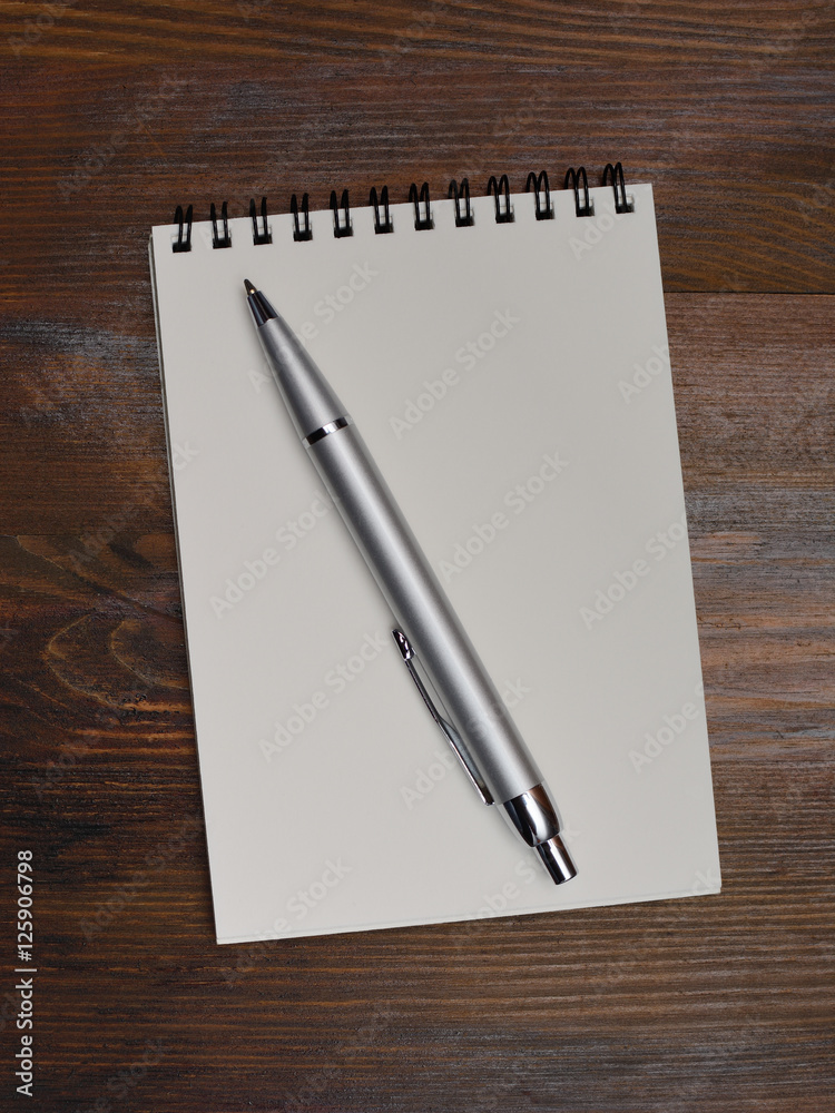 notebook and pen for notes on a background of wood texture notebook and pen for notes on a background of wood texture