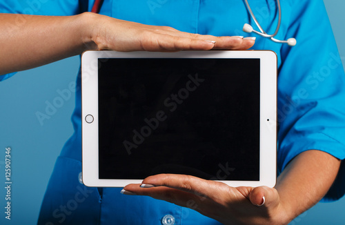 Doctor with a tablet in his hands, an empty space