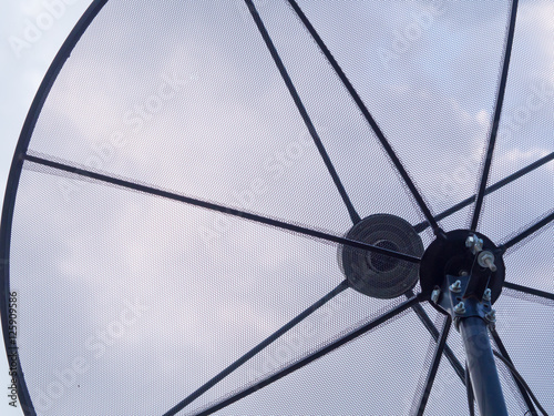 close-up satellite dish antennas with sky.