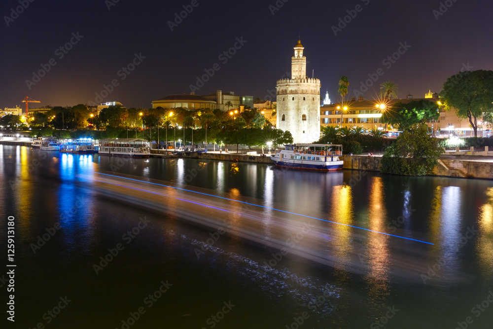 Dodecagonal military watchtower Golden Tower or Torre del Oro at night, Seville, Andalusia, Spain