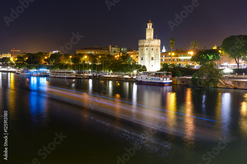 Dodecagonal military watchtower Golden Tower or Torre del Oro at night, Seville, Andalusia, Spain