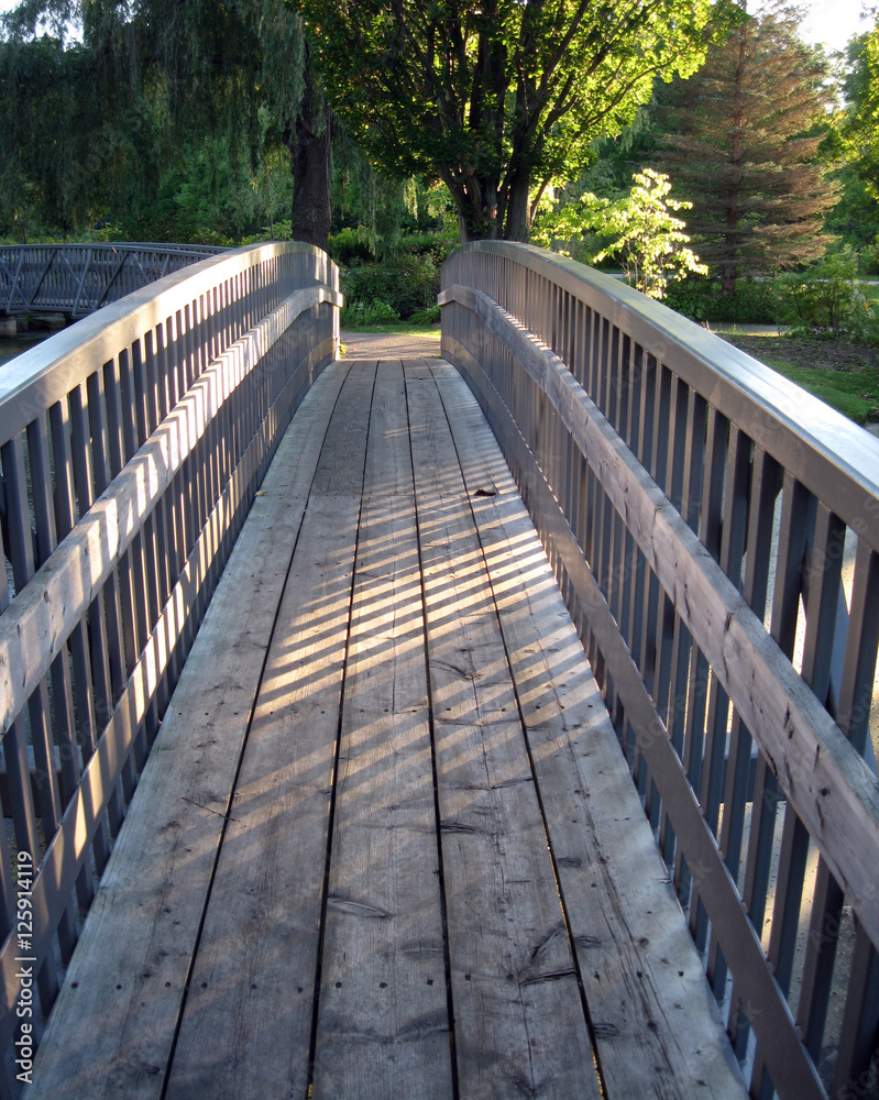 Sunlight and shadow on a small footbridge.